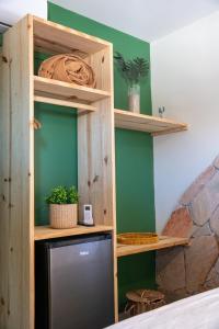 a tv in a wooden shelf in a room at Pousada Villa Velejo in Grossos +31 photos