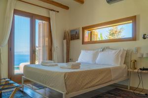 a bedroom with a bed with towels on it at Villa Mirabello Tholos Adults Only in Kavoúsion +131 photos