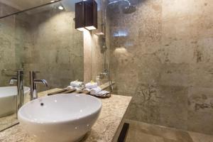 a bathroom with a sink and a shower at The Reika Villas by Nagisa Bali in Uluwatu