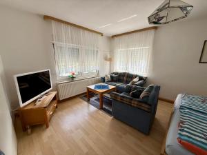 a living room with a couch and a tv at Rosenhof in Binz in Binz +84 photos