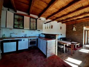 a kitchen with a table and a stove top oven at Jakabhegy vendégház in Szenna