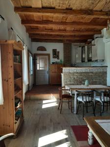 a kitchen with a table and chairs in a room at Jakabhegy vendégház in Szenna
