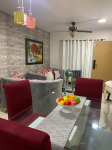 a living room with a glass table with a bowl of fruit on it at Casa Mamá Tere in Pantoja