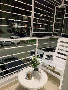 a white chair and a table with a flower on a balcony at Casa Mamá Tere in Pantoja