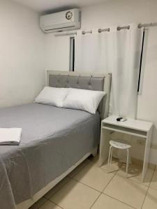 a bedroom with a bed and a nightstand with a bed and a air compressor at Casa Mamá Tere in Pantoja