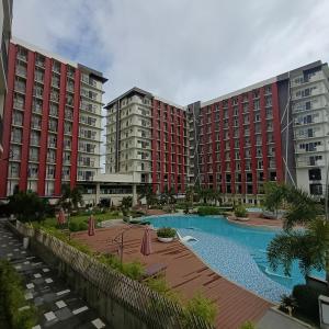 a view of two large apartment buildings with a swimming pool at Sanctuary 5125 by Primeworld District in Agus