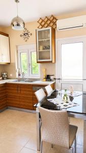 a kitchen with a table and chairs and a sink at Angela's House in Nea Plagia