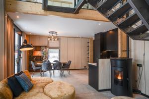 a living room with a couch and a fireplace at OplooPark Forrest Villa in Oploo