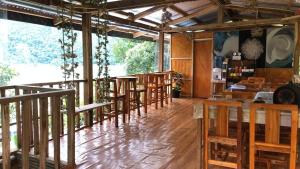 a restaurant with wooden tables and chairs in a room at Bale Cabugao Cottages Rental El Nido overlooking Beach in El Nido +33 photos