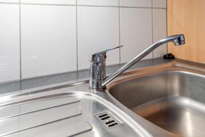 a stainless steel kitchen sink with a faucet at Haus Hauptstrasse 23a in Bühl +81 photos