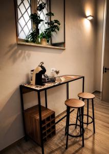 a table with two stools and a coffee maker on it at Da Nonna Iolanda in Caiazzo