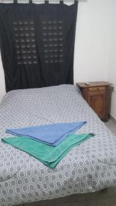 a pair of towels sitting on top of a bed at Yuntasuma II in San Fernando del Valle de Catamarca +2 photos