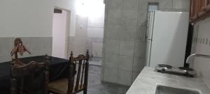 a kitchen with a sink and a refrigerator at Yuntasuma II in San Fernando del Valle de Catamarca
