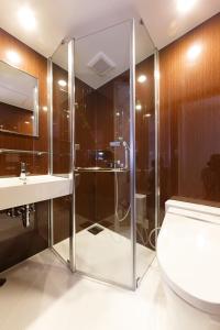 a bathroom with a shower and a toilet and a sink at Hotel Citio Shizuoka in Shizuoka