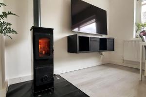 a living room with a fireplace and a tv at Mosel Appartment in Briedel in Briedel