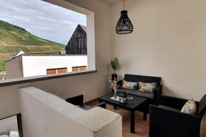 a living room with a couch and a table at Mosel Appartment in Briedel in Briedel