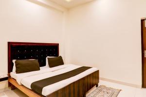 a bedroom with a large bed in a room at Hotel O KAILASHA INN in Hasanganj