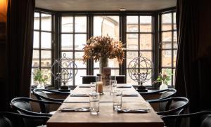 a long table in a room with a large window at The Greenman Fownhope Hereford in Fownhope