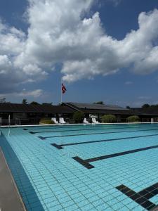 a large swimming pool with a flag on top of it at Kysthusene in Gilleleje +6 photos