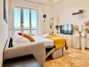 a bedroom with a large bed and a television at Bellavista Apartment Arcore in Arcore