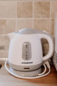 a white toaster sitting on top of a counter at Casa del Bosco in Rubiana +20 photos