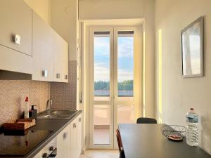 a kitchen with a sink and a door with a window at Bellavista Apartment Arcore in Arcore
