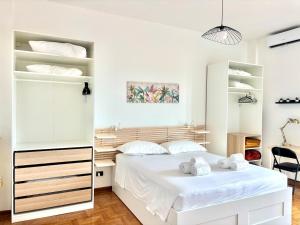 a bedroom with a white bed and shelves at Bellavista Apartment Arcore in Arcore