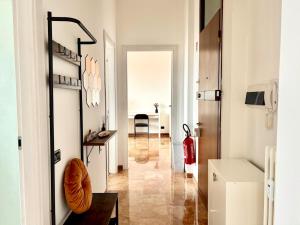 a room with a hallway with a table and a chair at Bellavista Apartment Arcore in Arcore +19 photos