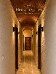 a hallway with a door with a sign that reads heaven gate sing costs at Heaven Gates Hotel in Siwa