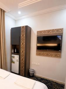 a hotel room with a microwave and a refrigerator at Luluat Al Badaie Hotel in Mecca