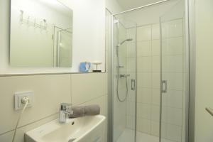 a bathroom with a shower and a sink at Marina Villa in Olpenitz +28 photos