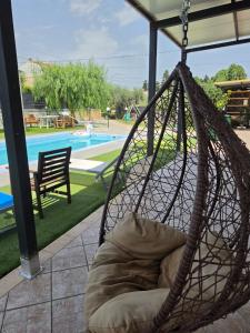a hammock in front of a swimming pool at Villa Marusia in Tollo