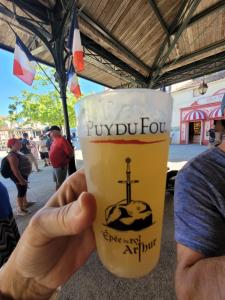 a person holding up a cup of coffee at Aumônerie du Prieuré in Pouzauges +44 photos