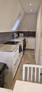 a kitchen with a sink and a stove top oven at Wee Cumbrae View in Millport