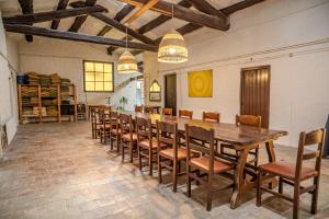 a large dining room with a long table and chairs at Les Eres de Guardiolans in Vilada