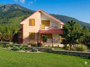 a house with a fence and a yard at Mountain View Retreat near Pelister National Park, Huge Garden, Hiking Paradise in Nižepole