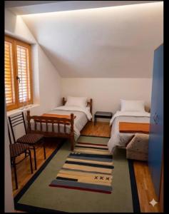 a bedroom with two beds and a rug at Mountain View Retreat near Pelister National Park, Huge Garden, Hiking Paradise in Nižepole