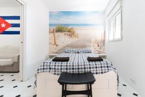 a bedroom with a bed and a boardwalk to the beach at El Rinconcito Cubano en el Centro in Almería