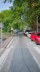 a street with cars parked on the side of the road at Familiar y Agradable in San Sebastián