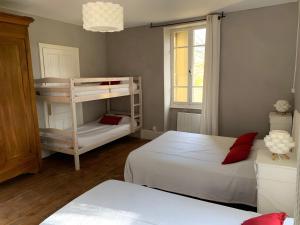 a bedroom with two beds and a bunk bed at Gite Des Sibourgs - Piscine & Clim in Bourdeaux +23 photos