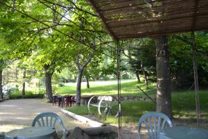 a group of tables and chairs under a pavilion at Gite Des Sibourgs - Piscine & Clim in Bourdeaux