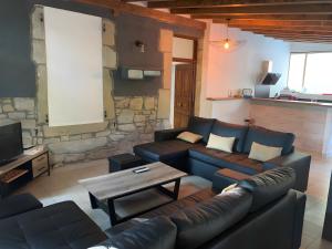 a living room with a couch and a table at Gite Des Sibourgs - Piscine & Clim in Bourdeaux