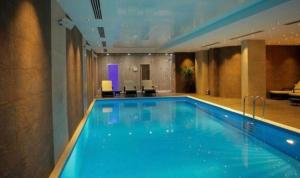 a large swimming pool in a hotel room at Orbi Palace Bakuriani in Bakuriani