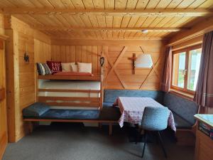 a room with a bed and a table in a cabin at Ciasa Lovara in Lovara