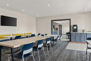 a conference room with tables and blue chairs at City Express By Marriott Gettysburg in Gettysburg