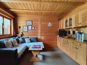 a living room with a couch and a table at Ciasa Lovara in Lovara