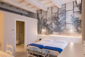 a bedroom with two beds and a painting on the wall at Villa Mirandola in Mirandola +68 photos