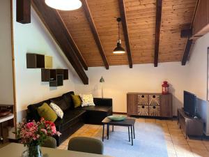 a living room with a couch and a table at la Mansarda dello Zio in Ceppo Morelli
