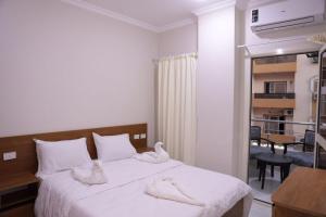 a bedroom with a bed with towels on it at جراند فاندا سويتس الغردقه Grand Vanda Suites Hurghada in Hurghada