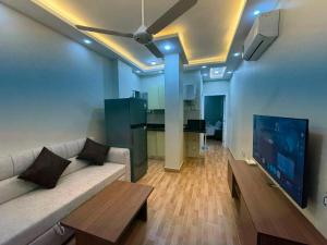 a living room with a couch and a flat screen tv at جراند فاندا سويتس الغردقه Grand Vanda Suites Hurghada in Hurghada